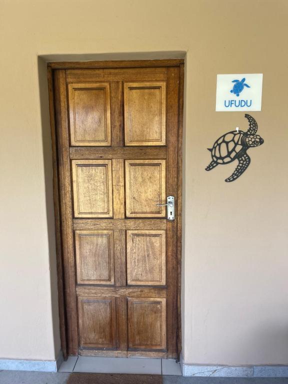 a door to a room with a turtle on the wall at Ufudu Chalet in Mbazwana