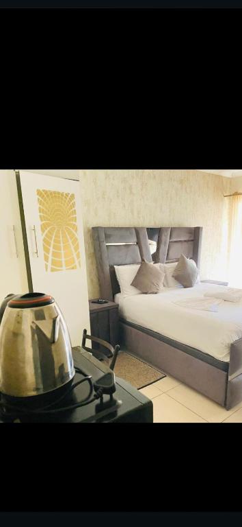 een slaapkamer met twee bedden en een tafel met een lamp bij SUNFLOWER bed and breakfast in Ladysmith