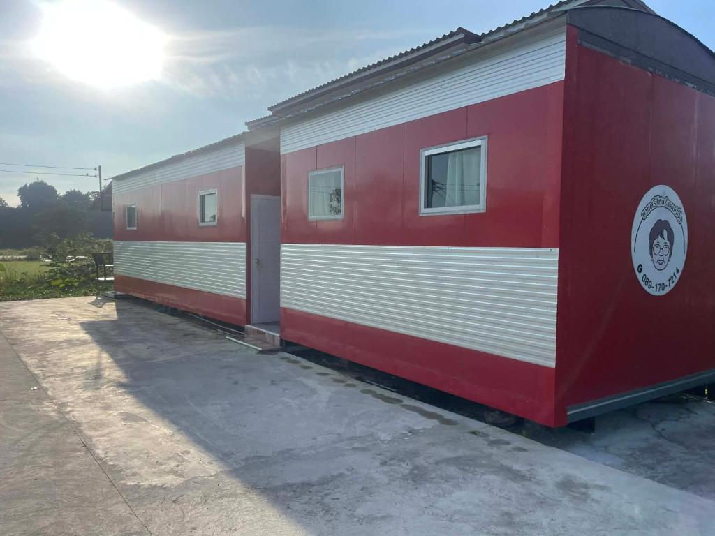 a red and white train car parked in a lot at SriHOME in Ban Don Tum (1)