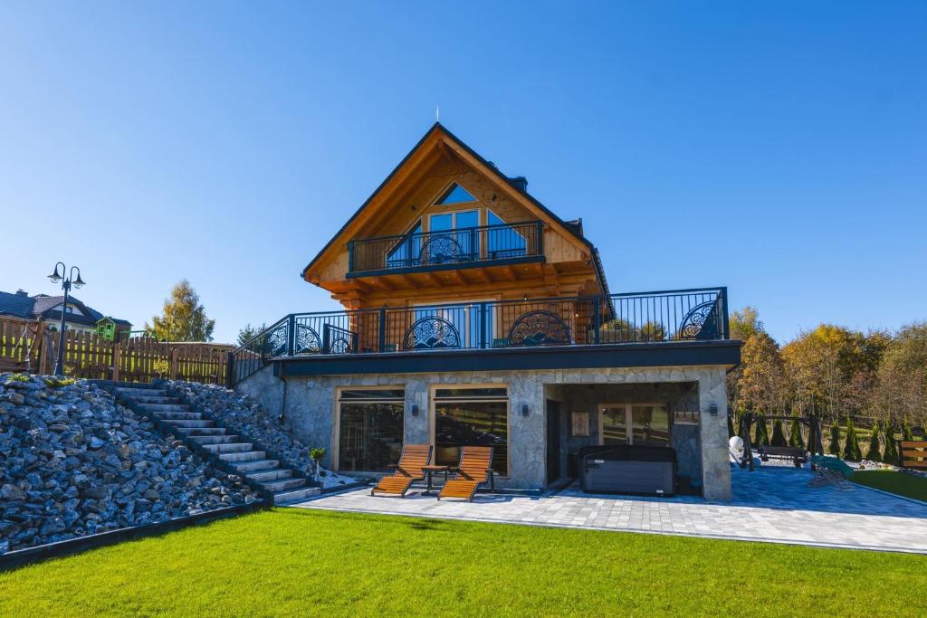 a house with a gambrel roof on top of it at Widokowa Chata Istebna Trójwieś in Istebna