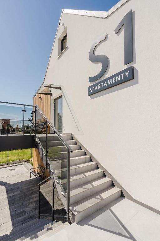 a set of stairs in front of a building at S1 Apartamenty in Rewa