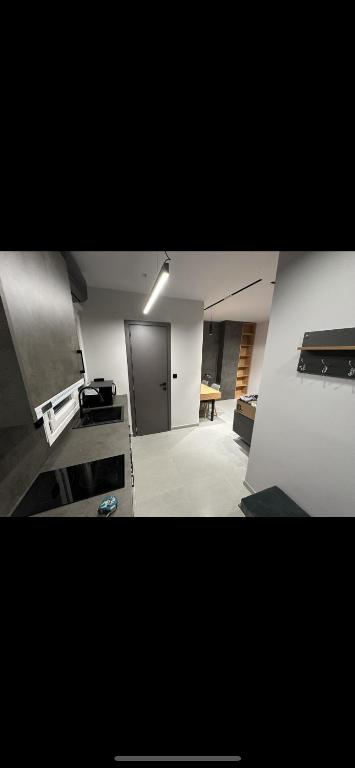 an empty room with a kitchen and a hallway at Lux Central Apartment in Kilkís