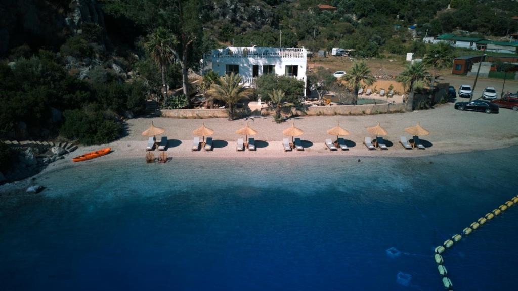 an aerial view of a beach with chairs and umbrellas at Villa Castelle in Marmaris