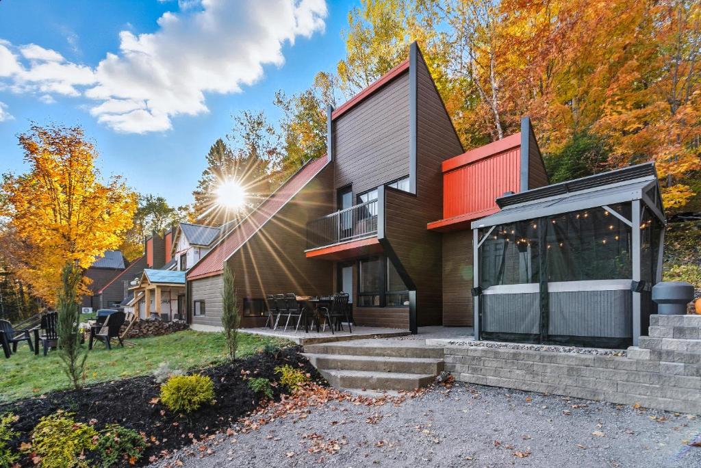 a house with a red roof at Spa & Nature view - Alpenglow in Sainte-Germaine-du-Lac-Etchemin