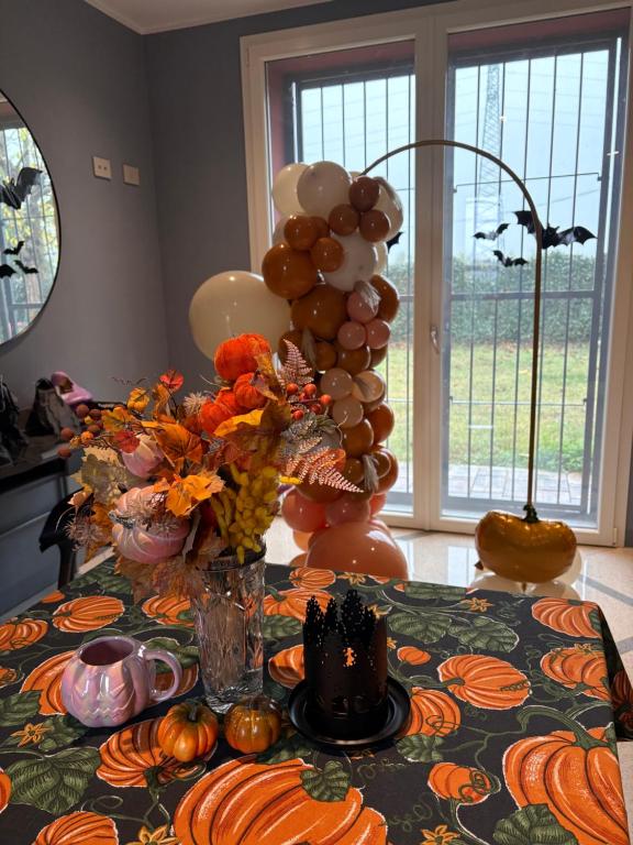 a table with a bunch of balloons and pumpkins at Sala dell Estate Guest House in Secchia