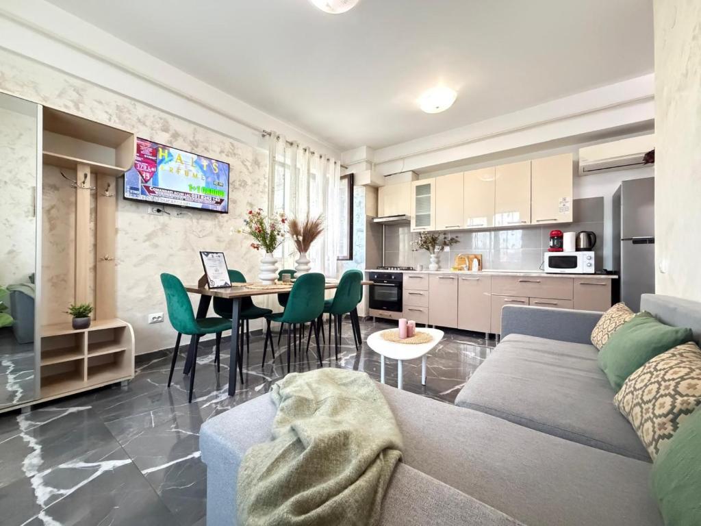 a living room and kitchen with a couch and a table at Studios Palas by GLAM Center Area and Mall - Parking Option in Iaşi