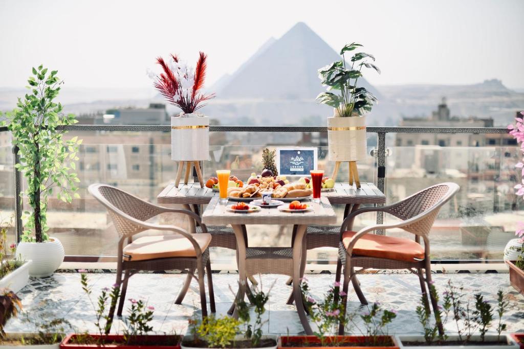 开罗Legend Pyramids Inn的阳台上的餐桌上摆放着食物