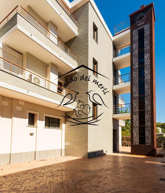 a building with a sign on the side of it at Il Nido dei Merli in Fiumicino