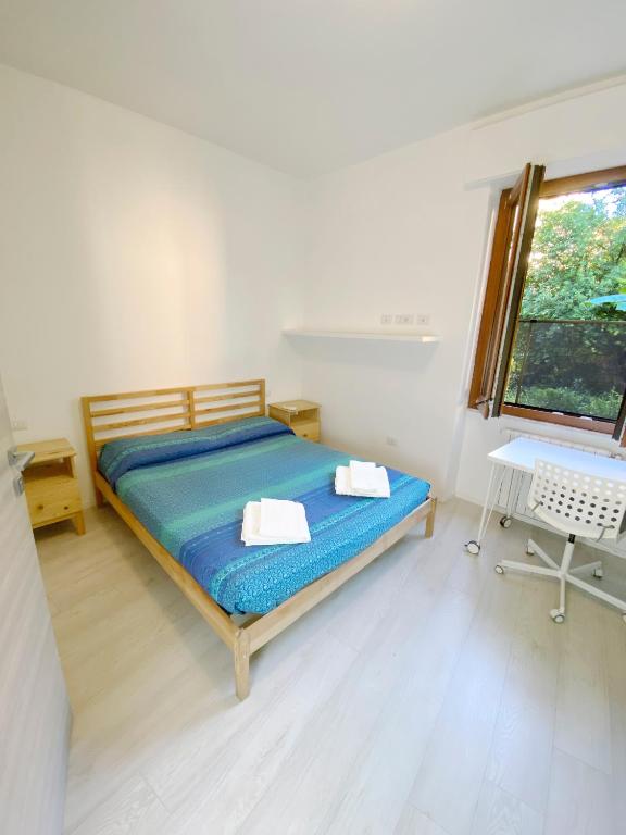 a bedroom with a bed with two towels on it at Birsa's Rooms in Cagliari