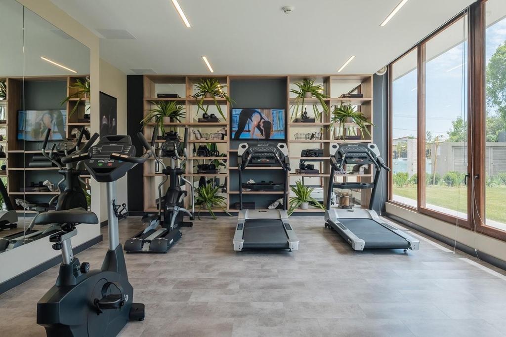 a gym with treadmills and ellipticals in a room at Lujo y confort en el corazón de Santiago in Santiago