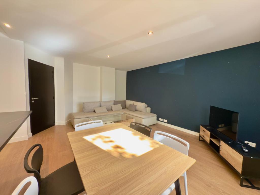 a living room with a table and a couch at T4 moderne parking Théodore Bac - DABNB in Limoges