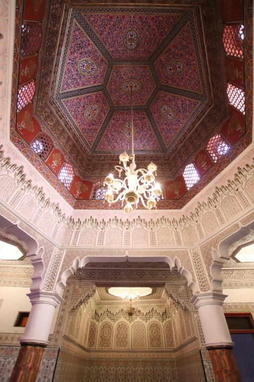 Un techo de un edificio con una lámpara de araña. en Emerald palace, en Marrakech