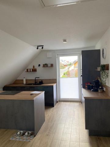 a kitchen with a staircase leading to a door at Ferienwohnung Auszeit in Marsberg