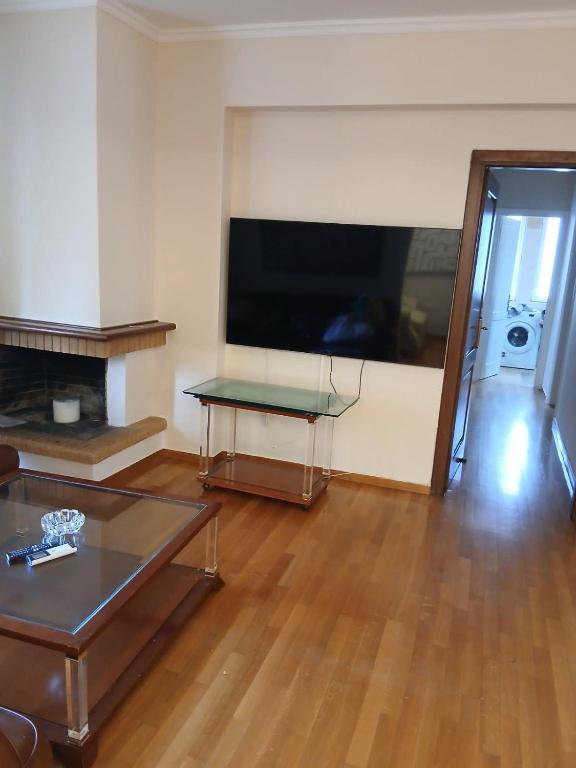 a living room with a large flat screen tv at Stylish Luxury 3 Bd Penthouse in Drosia Center in Drosia