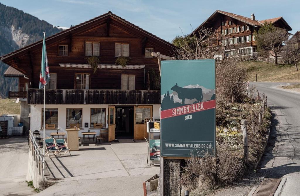 a sign in front of a building with a lodge at Chalet Brauerei in Lenk