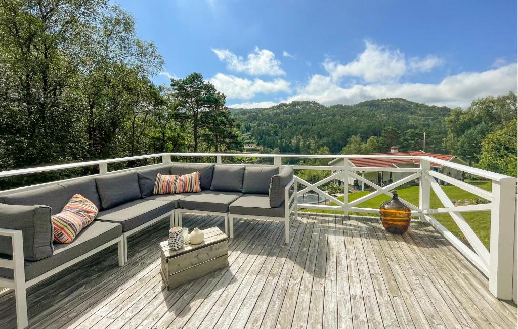 a couch on a deck with a view of the mountains at 1 Bedroom Cozy Home In Førde I Hordaland in Erve