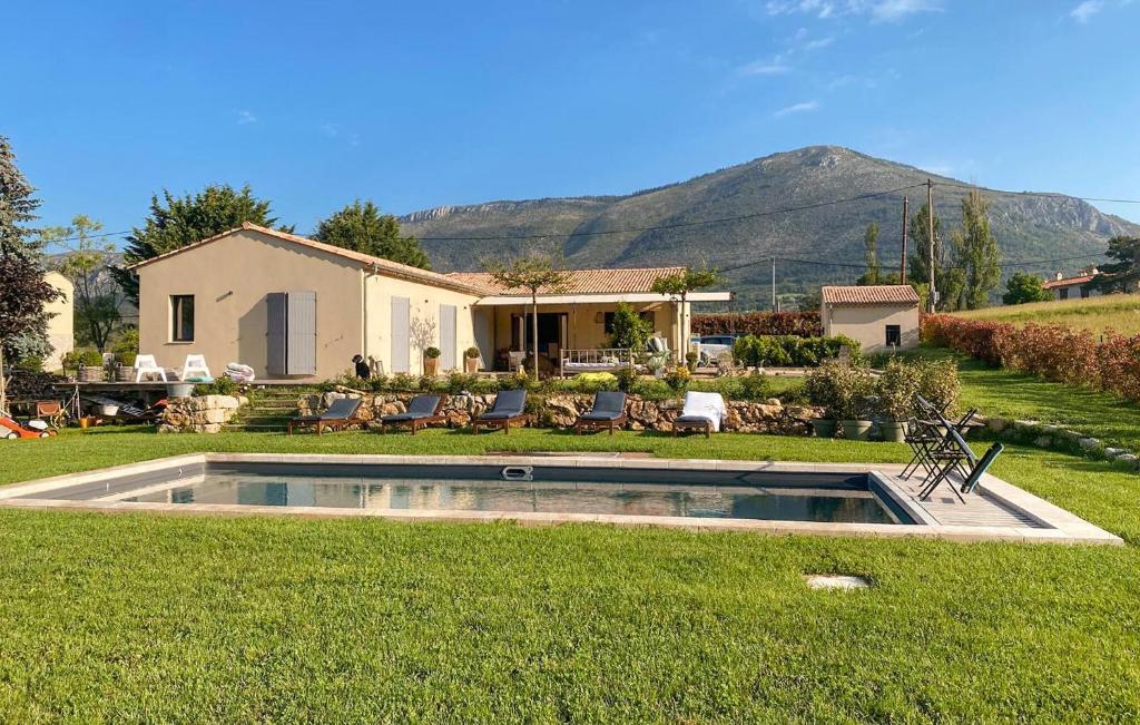 a house with a swimming pool in the grass at Maison Avec Piscine in La Roque-Esclapon