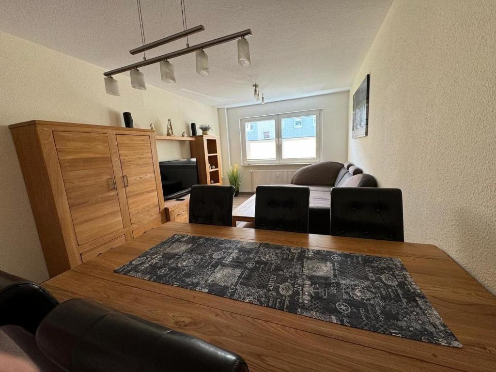 a living room with a table and a couch at Schöne Gästewohnung zum Erholen in Bad Sülze