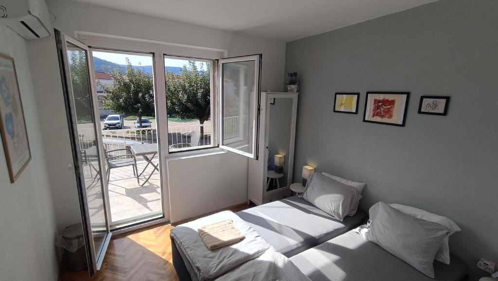ein Schlafzimmer mit einem Bett und einem großen Fenster in der Unterkunft Oleas Stari Grad Hvar - RoomsNew - 2 Min to Sea and Center in Stari Grad
