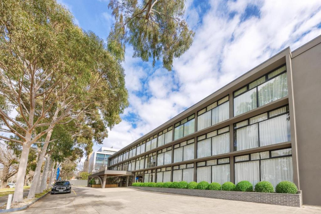 an office building with a car parked in front of it at Park Inn by Radisson Melbourne Carlton in Melbourne