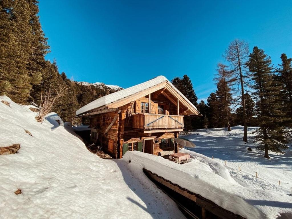 a log cabin in the snow on a mountain at Turracher Hütte in Turracher Hohe