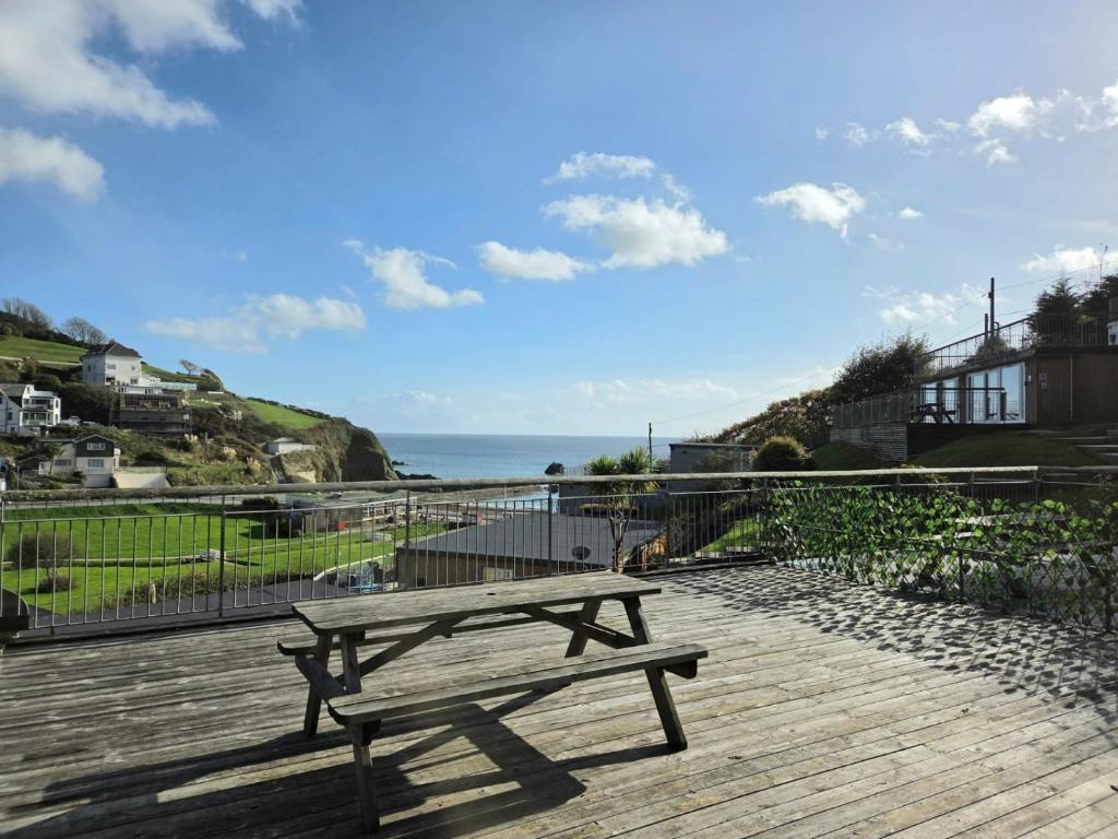 a wooden bench sitting on top of a wooden deck at Millendreath Oean View Villa in Saint Martin
