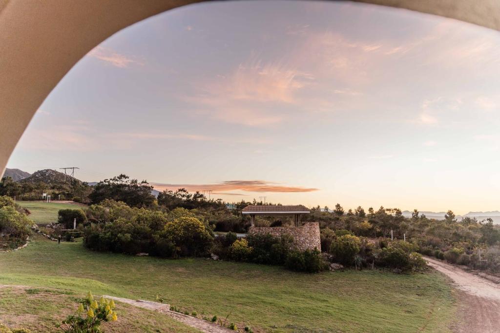 a view of a house on a hill with a road at Barton Luxury Villas in Botrivier