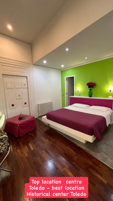 a bedroom with a large bed and a green wall at Donnalbina 7 The Fresh BB in Naples