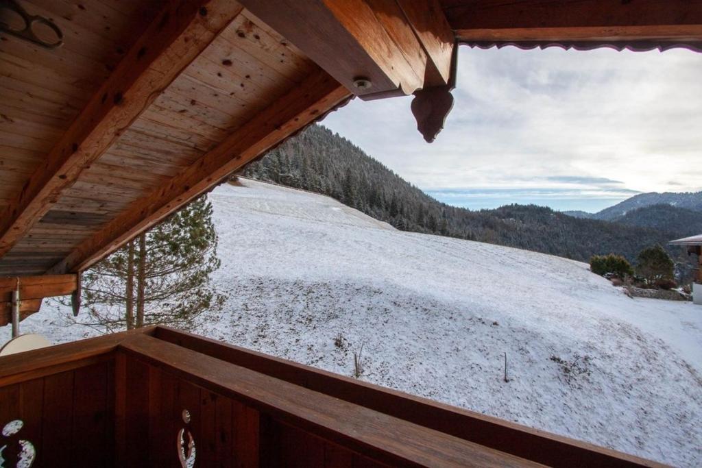 a view of a snowy mountain from the balcony of a cabin at Chalet Luxeck in Steinberg am Rofan