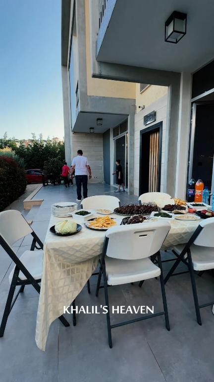 a table with plates of food on top of it at Khalil's Heaven Villa in ‘Ayn al Ḩalazūn