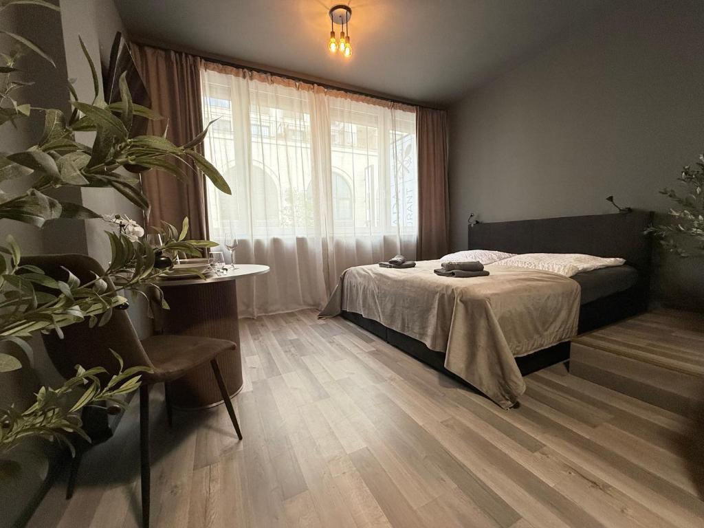 a bedroom with a bed and a large window at M-Studio Apartments in Stuttgart Zentrum in Stuttgart