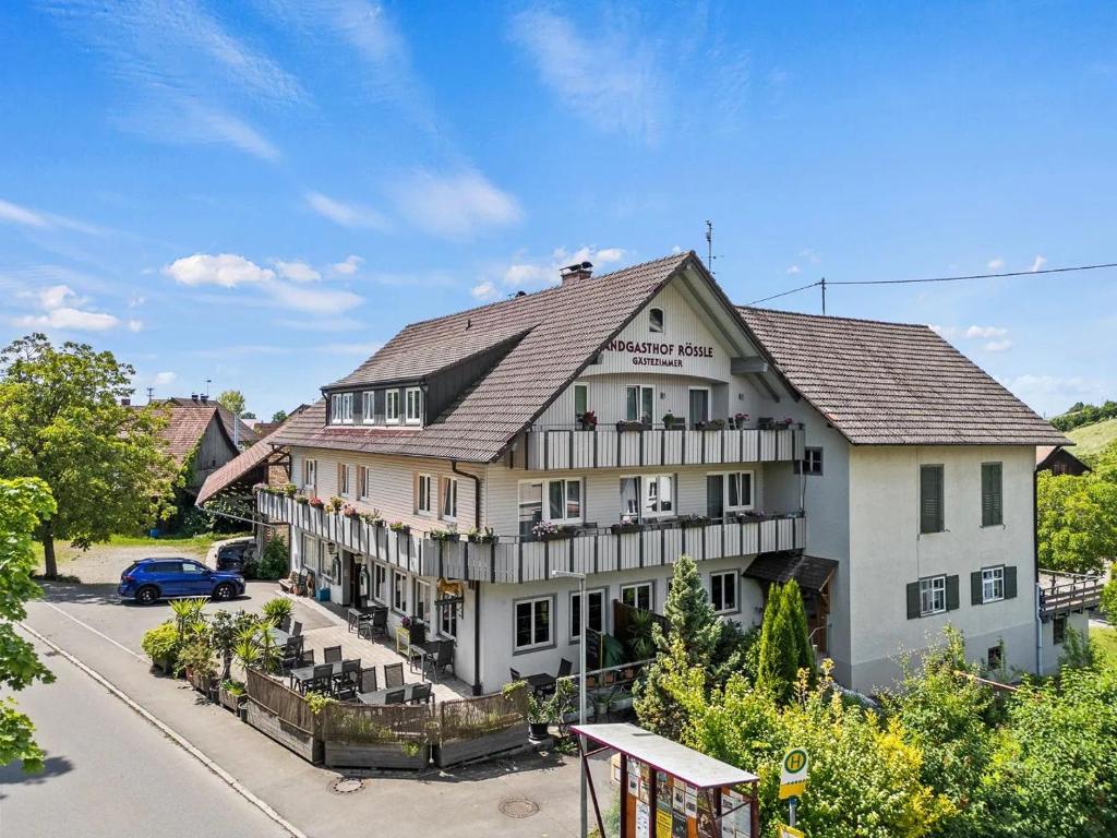 a large white building on the side of a street at Landgasthof Rössle in Kressbronn am Bodensee