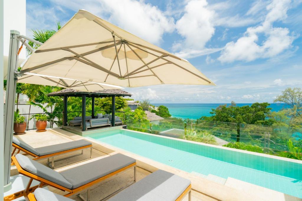 a villa with a swimming pool and an ocean view at Surin Heights Villa in Surin Beach