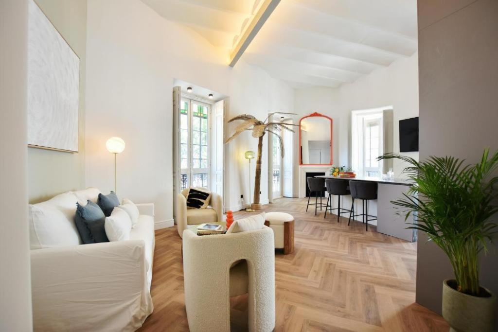 a living room with a white couch and a table at Antonia Luxury Home in Seville