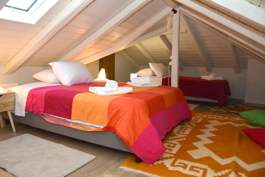 a bedroom with a large bed in an attic at Αρσινόη apartments 4 in Arachova