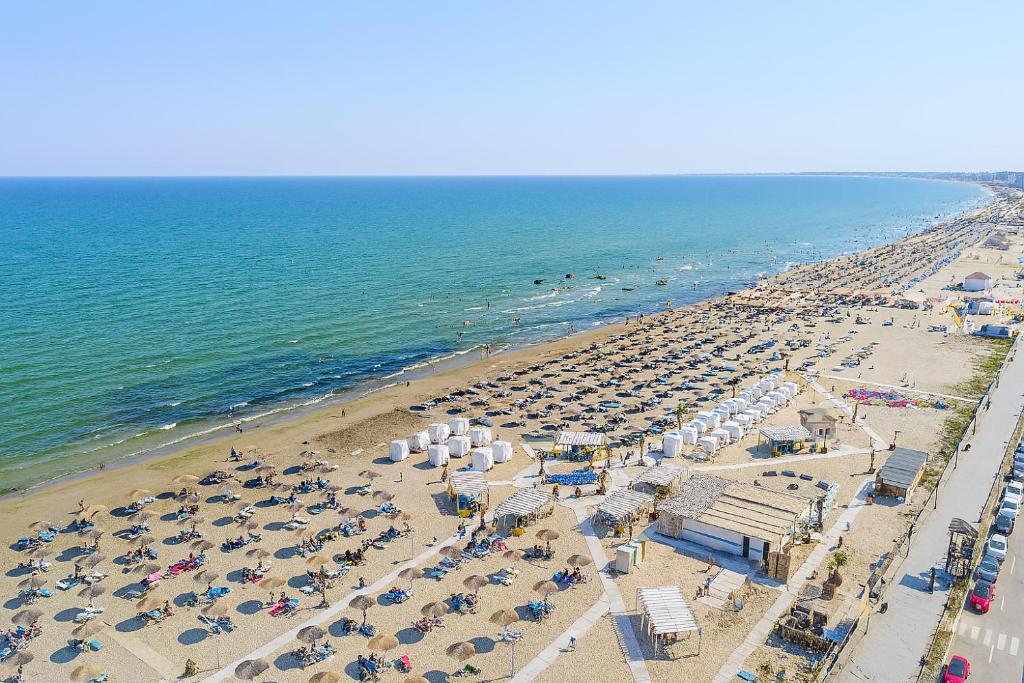 an aerial view of a beach with umbrellas and the ocean at Signature Promenada Beach in Mamaia Nord