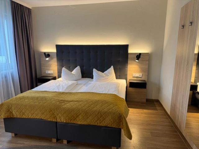 a bedroom with a large bed in a room at Vinotel Dirmstein in Behringen