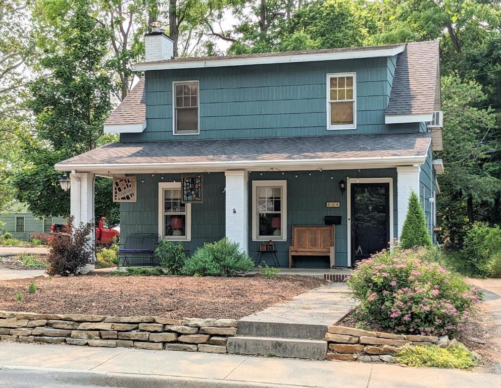 a blue house with a porch and a driveway at Hot Tub 3 Kings Close To Everything in Bloomington
