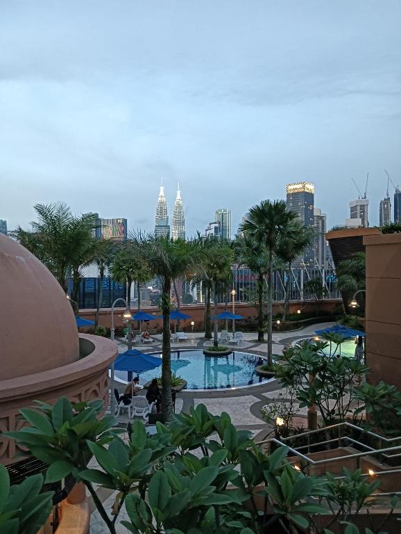 a view of a pool with a city in the background at Crown Suits At Times Square in Kuala Lumpur