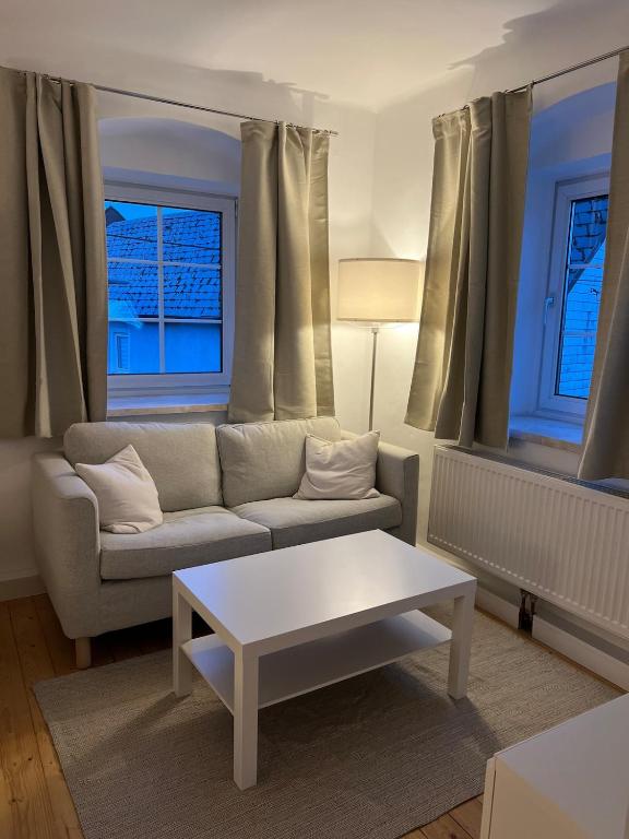 a living room with a couch and a coffee table at Yellow House Apartments - Top 3 in Steyr