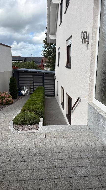 a white building with a driveway and a garage at LembergLodge Gosheim in Gosheim