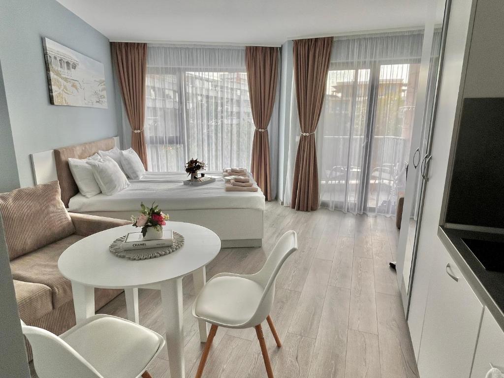 a living room with a bed and a table and chairs at IvI Apart Villa EMA in Kranevo