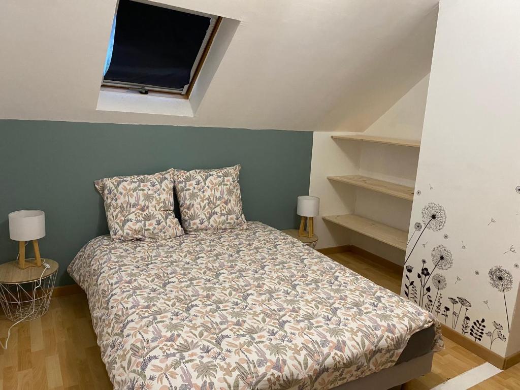 a bedroom with a bed and a window and shelves at Le Numéro 2 in Ornans