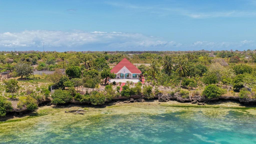 an aerial view of a house on a island in the water at Menai Bay Escape in Mkunguni