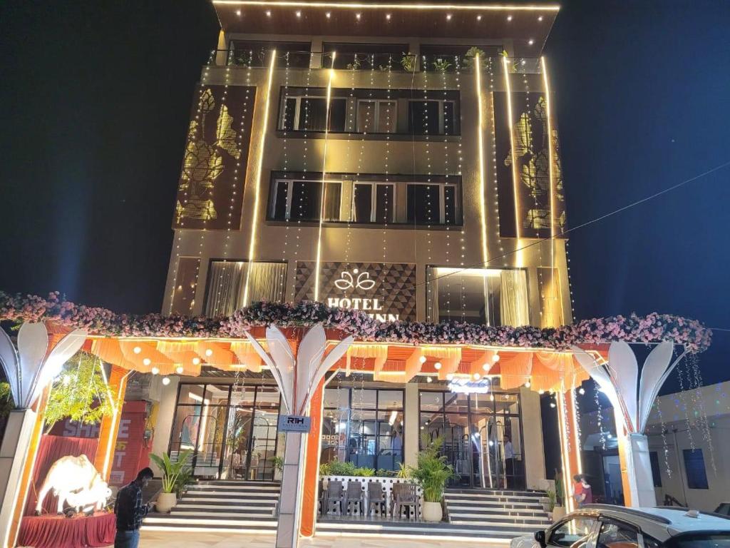a large building with a store front at night at lotusinn in Bānswāra