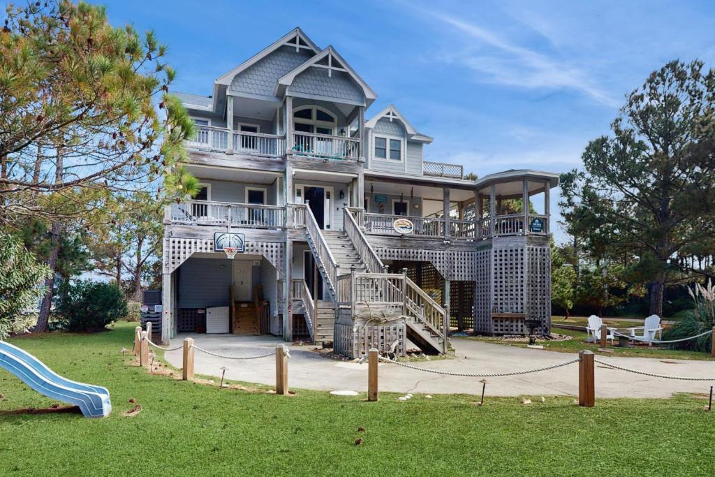 a large house with a playground in front of it at WV09 Play Time in Waves