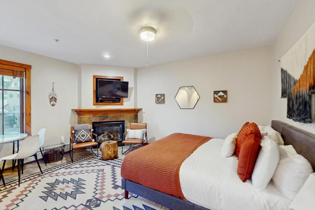 a bedroom with a bed and a fireplace at Main Street Station #1210 in Breckenridge