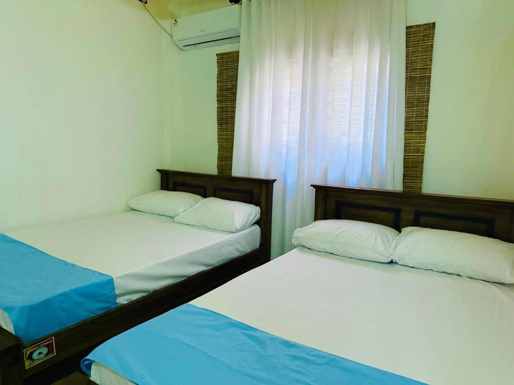 two beds sitting next to each other in a room at The Lotus House - Ahangama in Ahangama