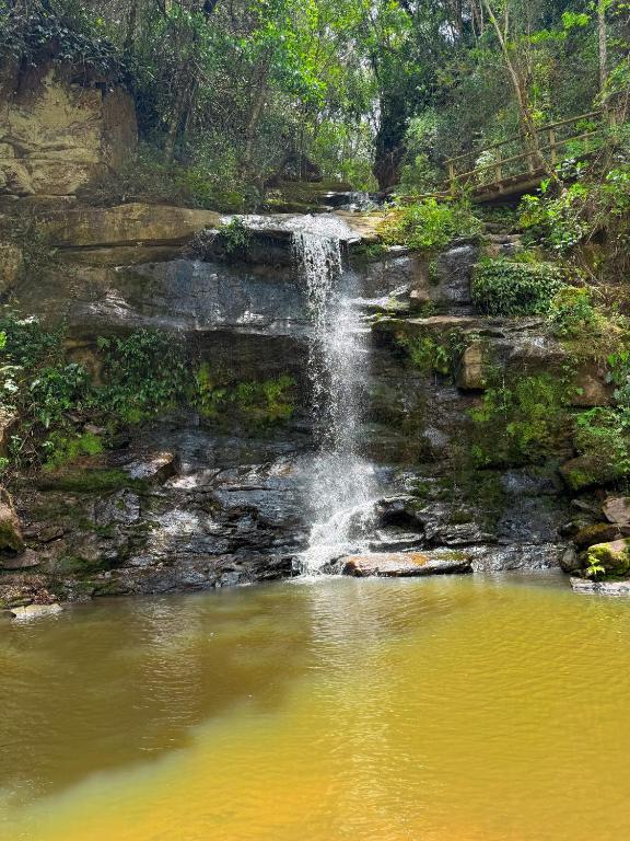 a waterfall in the middle of a pond at Pousada Shangri-lá in Cunha