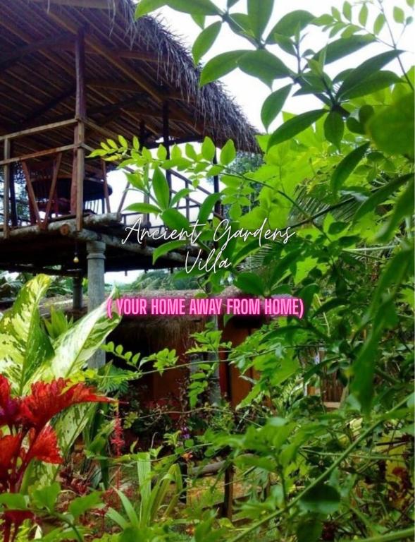 a picture of a garden with ayour home away from home sign at Ancient Gardens Villa in Pinnawala
